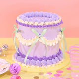Vintage Cake - Tonal Colour by Crumbs & Doilies, tall 6-layer cake with purple and cream Swiss Meringue icing and ribbon decoration.